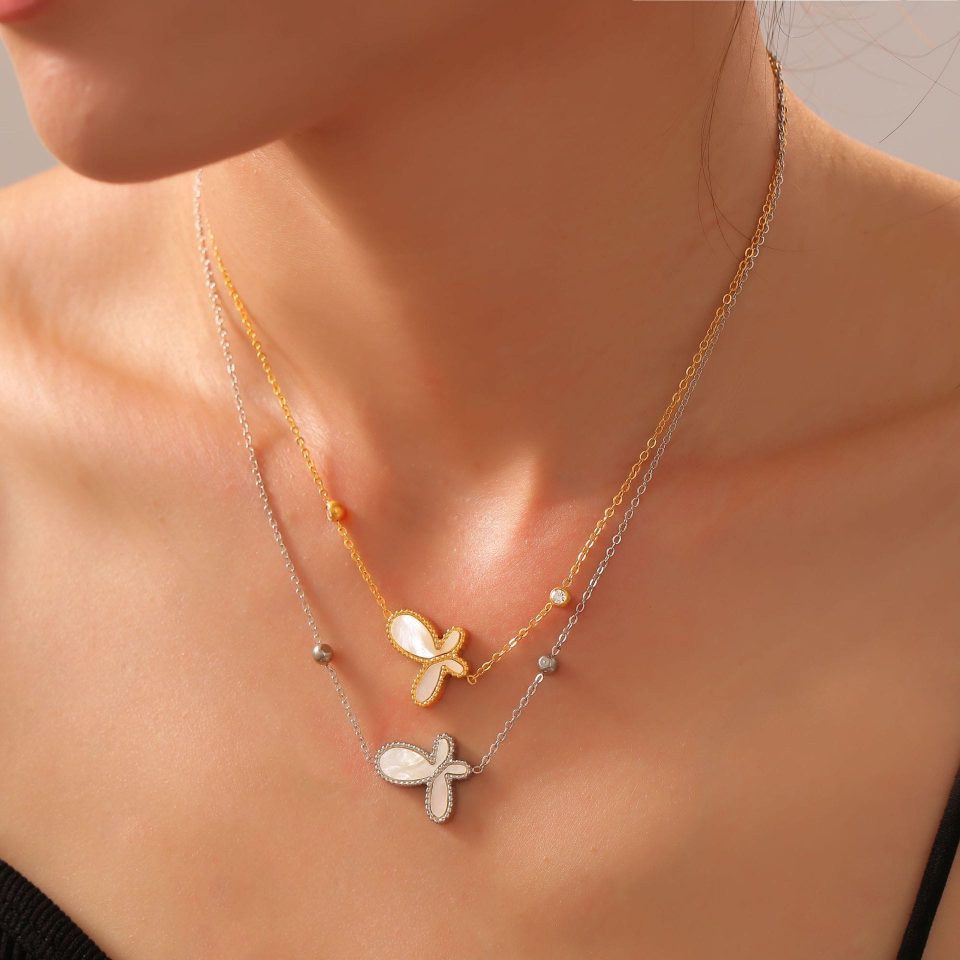 Model layering gold and silver butterfly shell pendant necklaces