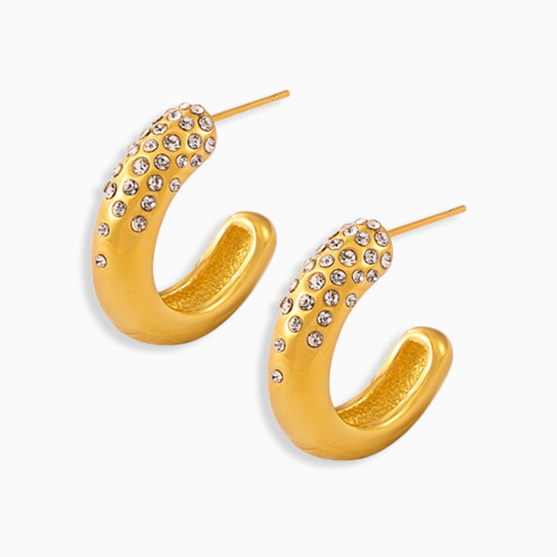 Gold sculpted C-hoop earrings with micro-pavé detail on white background