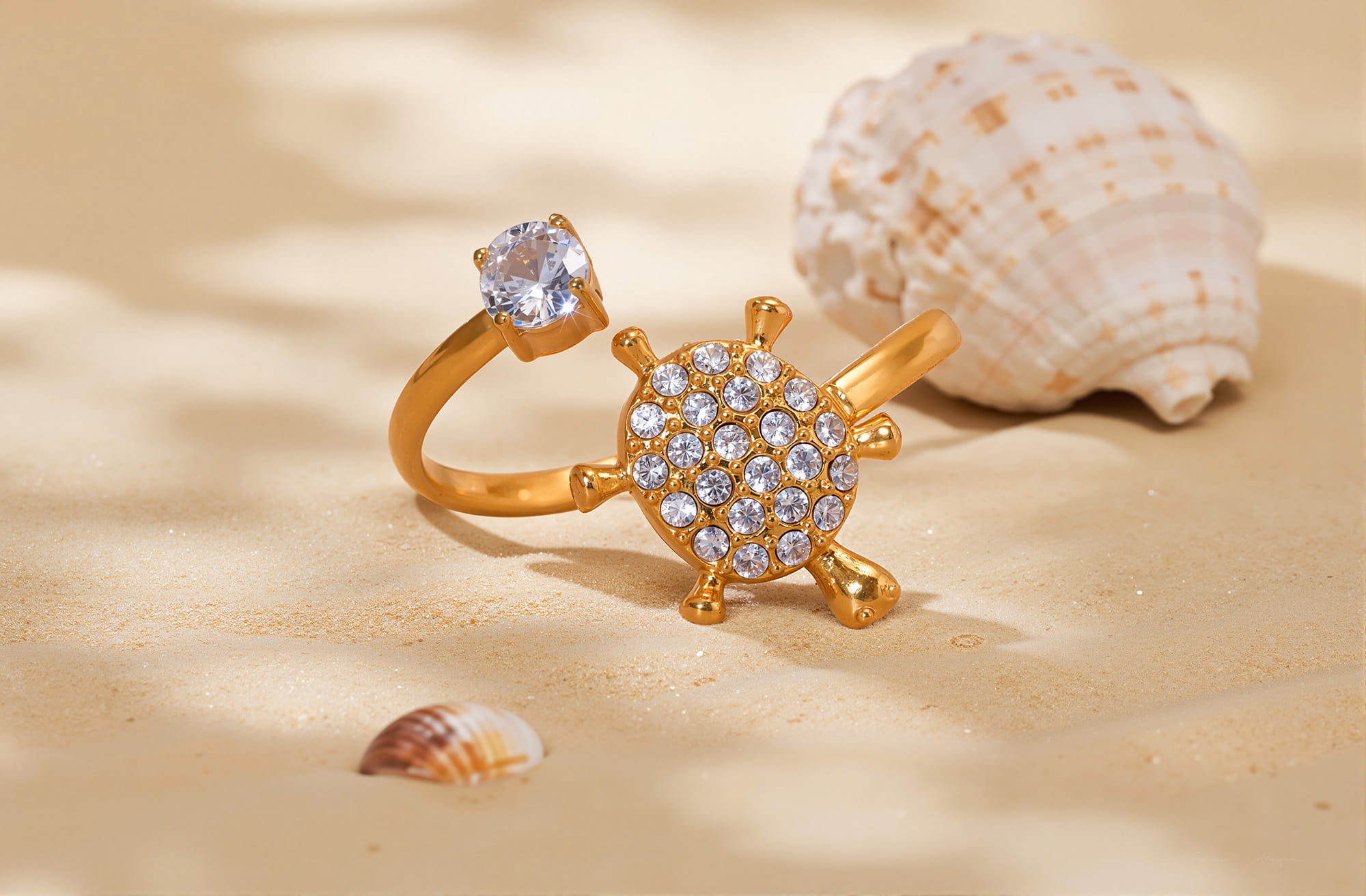Sea turtle gold ring with sparkling stones and open band on sand
