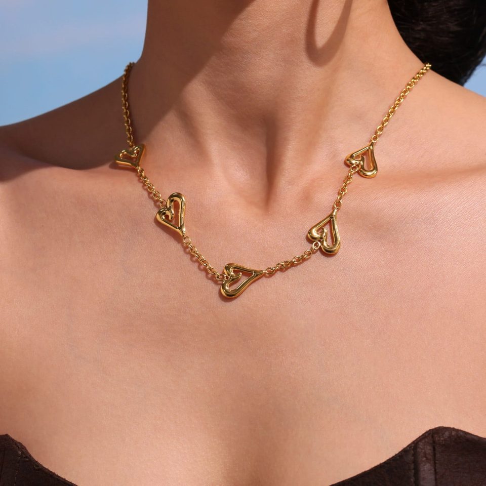 wearing model's gold heart necklace txp267