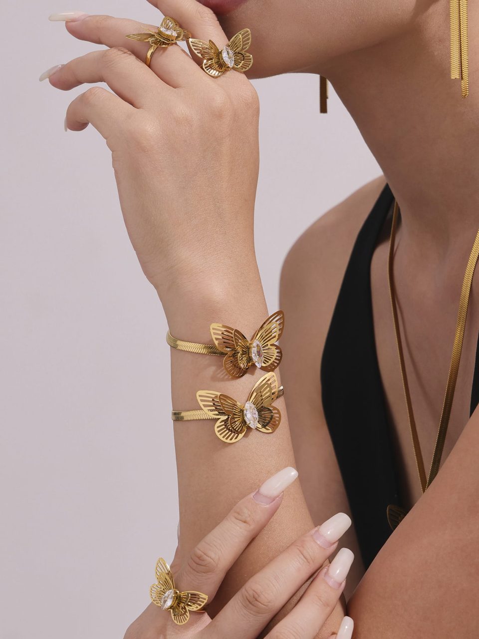 Model wearing a gold butterfly zircon bracelet TXE324
