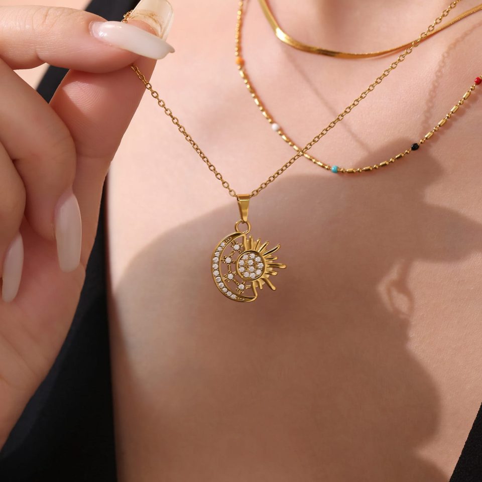 Model wearing a gold zircon necklace with sun and moon P2158-