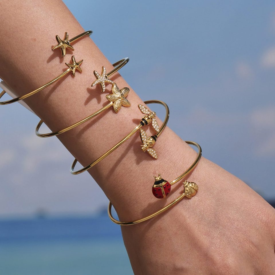 Model wearing gold double ladybug bangle Z472