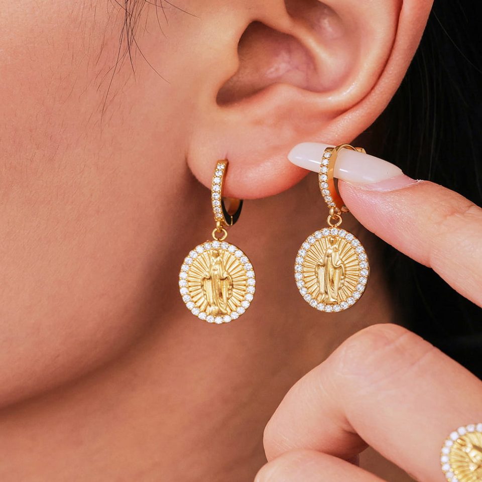 Model wearing 5A CZ Jesus Oval Hoop Earrings in gold stainless steel