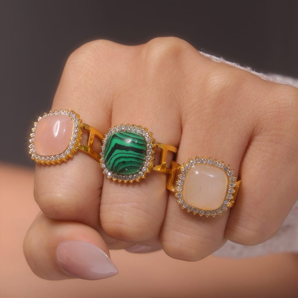 Model wearing three stainless steel cubic zirconia adjustable rings in different natural stone colors