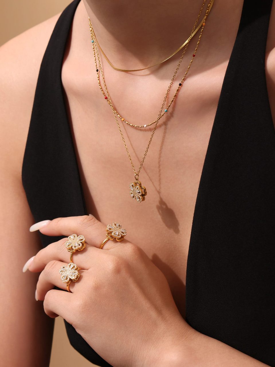 Model wears a gold 5A zircon rotating flower ring TXA3