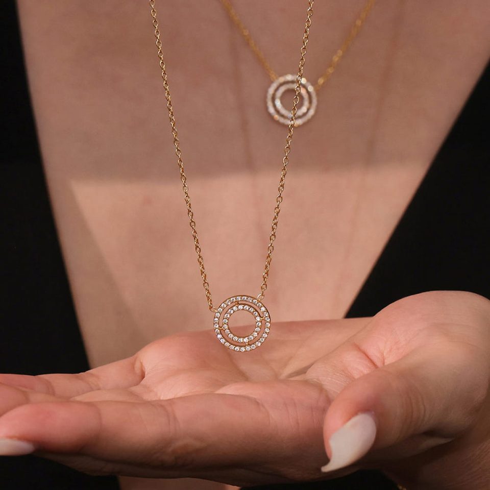 Model wears gold 5A zircon double ring necklace TXP307