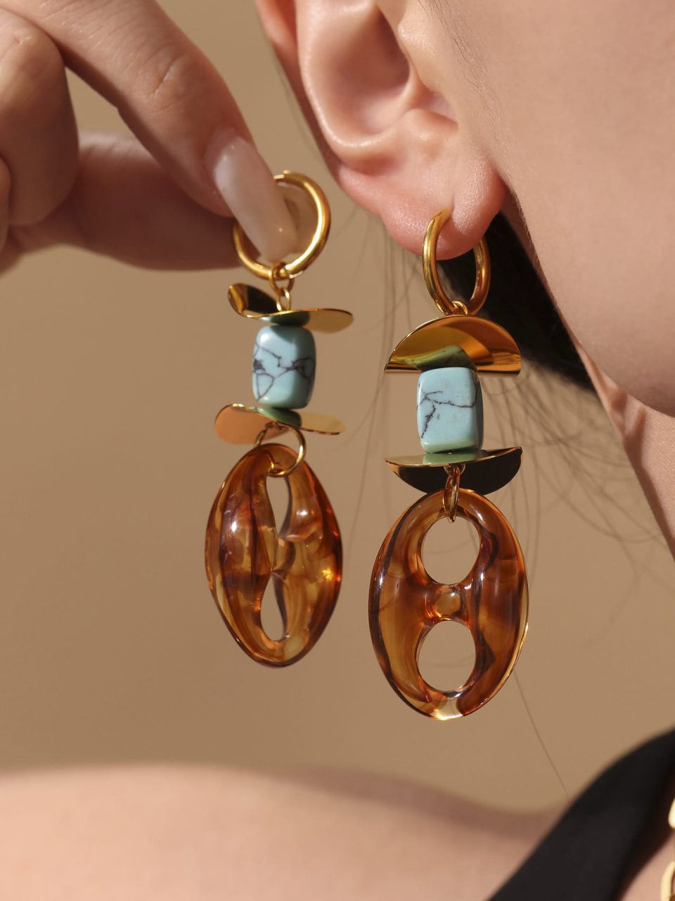 Model wears gold turquoise resin earrings TXF309----