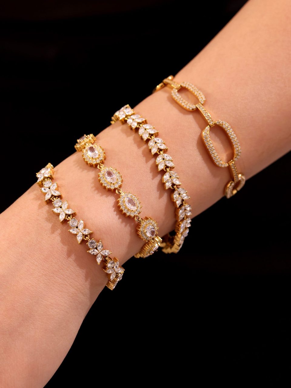 Model wearing the gold four-leaf clover CZ bracelet – full pave stainless steel jewelry