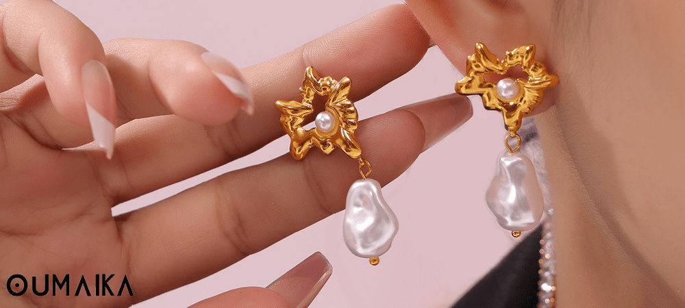 Model wearing gold shell pearl earrings with geometric freshwater pearl hoops, hypoallergenic stainless steel design