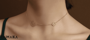Young woman smiling while wearing OumaiKa four-leaf clover zircon necklace in natural daylight, showcasing hypoallergenic stainless steel jewelry