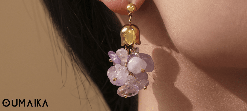 Model wearing purple tassel earrings with natural crystals crafted in hypoallergenic stainless steel