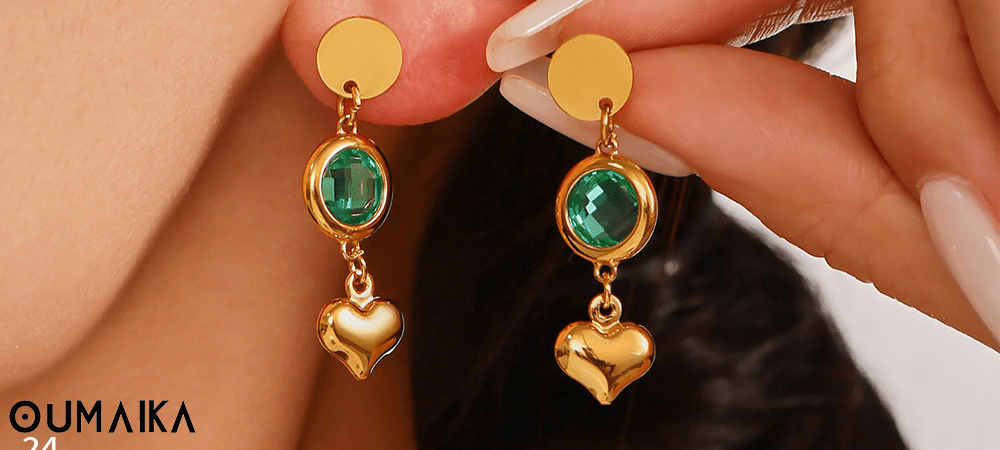 Model wearing ocean-inspired hypoallergenic stainless steel dangler earrings with shell and wave design