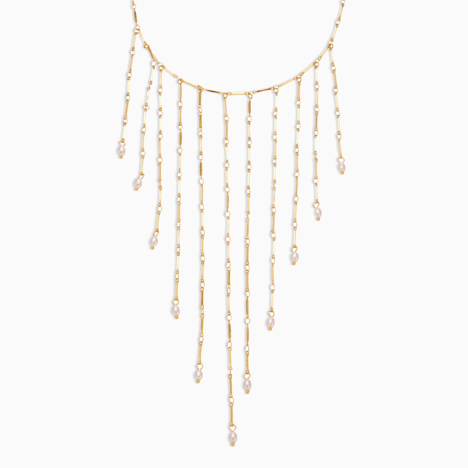 Chunky pearl necklace with imitation gold pearls and tassel on white background