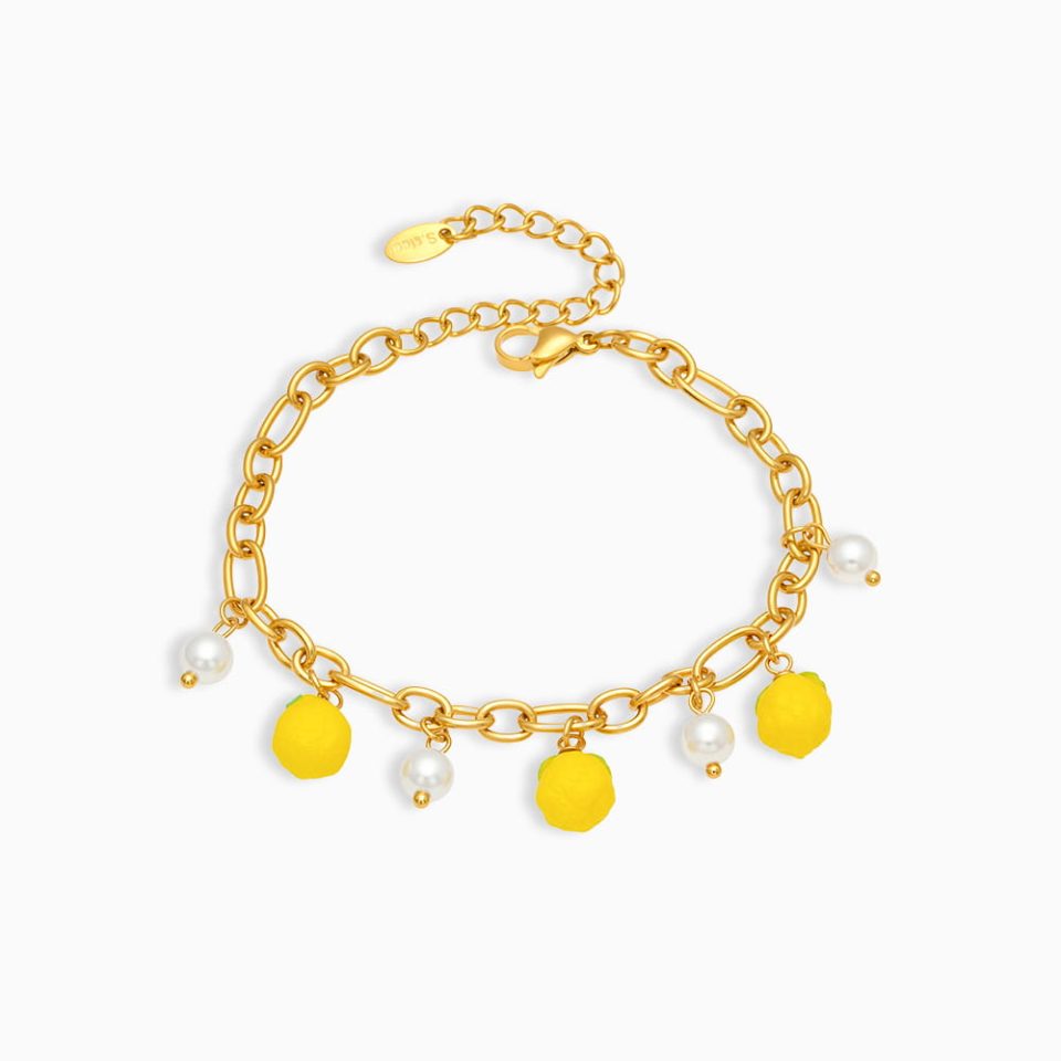 Gold bead bracelet with lemon resin and shell charms on white background, stainless steel jewelry