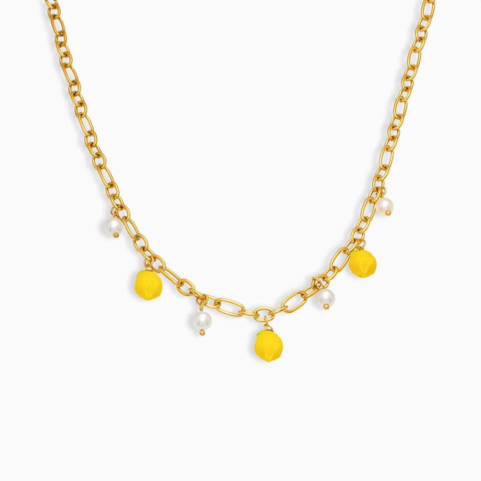 Gold bead necklace with lemon resin and shell pendant on white background