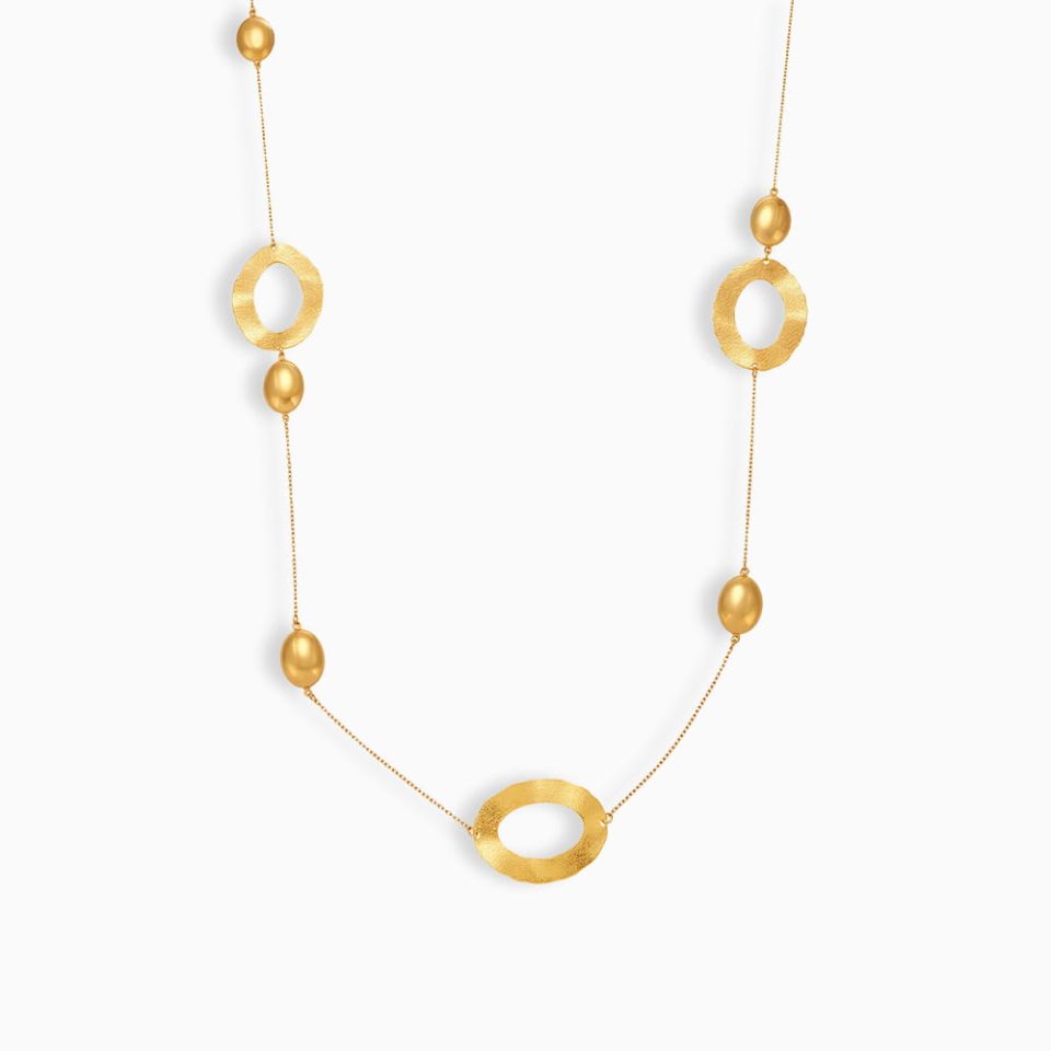 Hammered oval pendant gold long necklace with PVD plating on white background