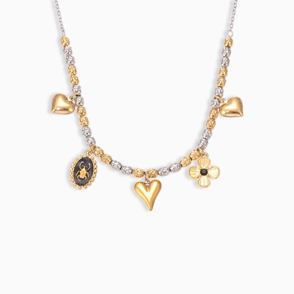 Gold heart flower necklace on white background – Oumaika Jewelry