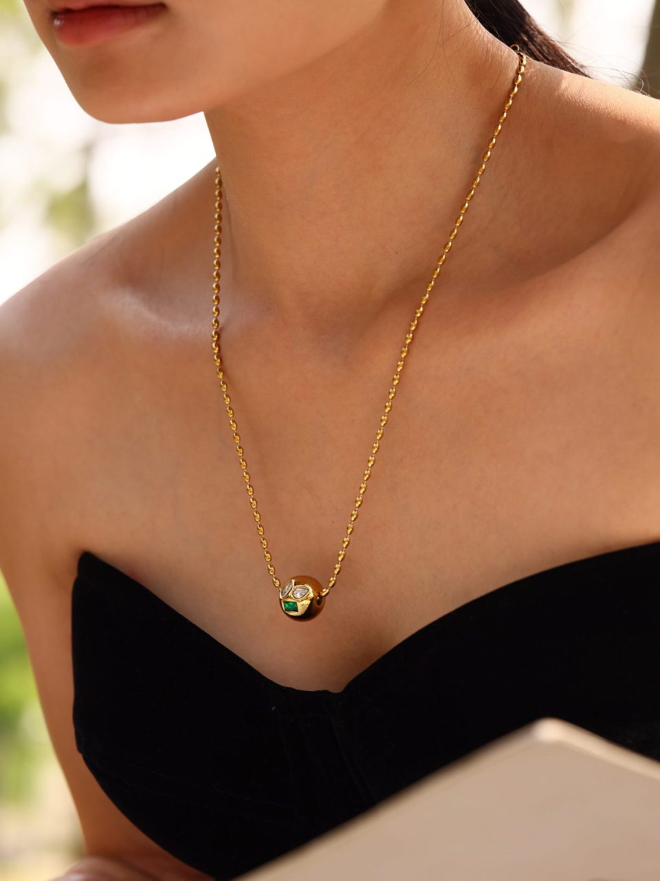 Model wearing green cubic zirconia beaded necklace, stainless steel choker chain jewelry