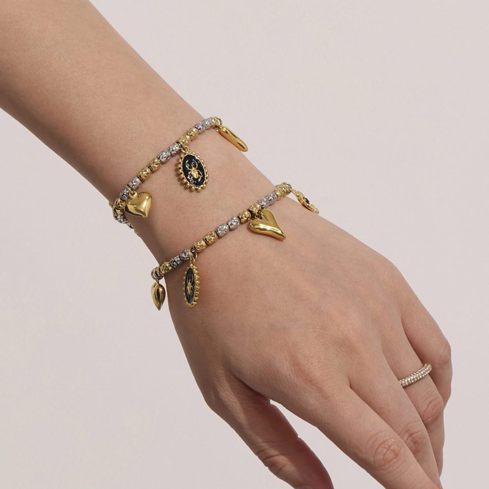 Model wearing a gold heart bracelet TXE338