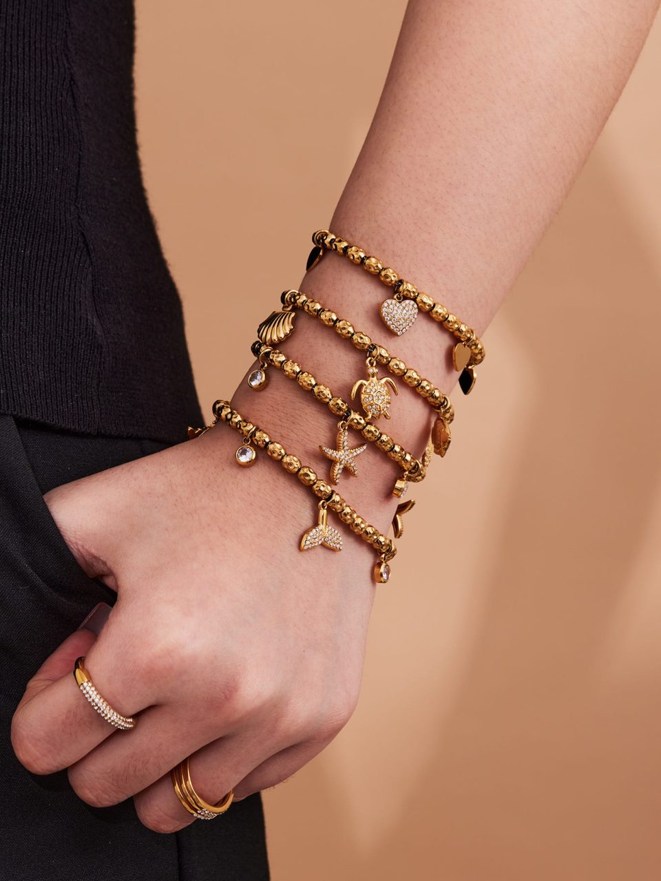 Model wearing Gold Beaded Stainless Steel Bracelet with Mermaid Tail and Starfish Charms