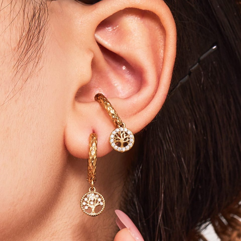 Model wearing Tree of Life Cubic Zirconia Earrings in gold stainless steel