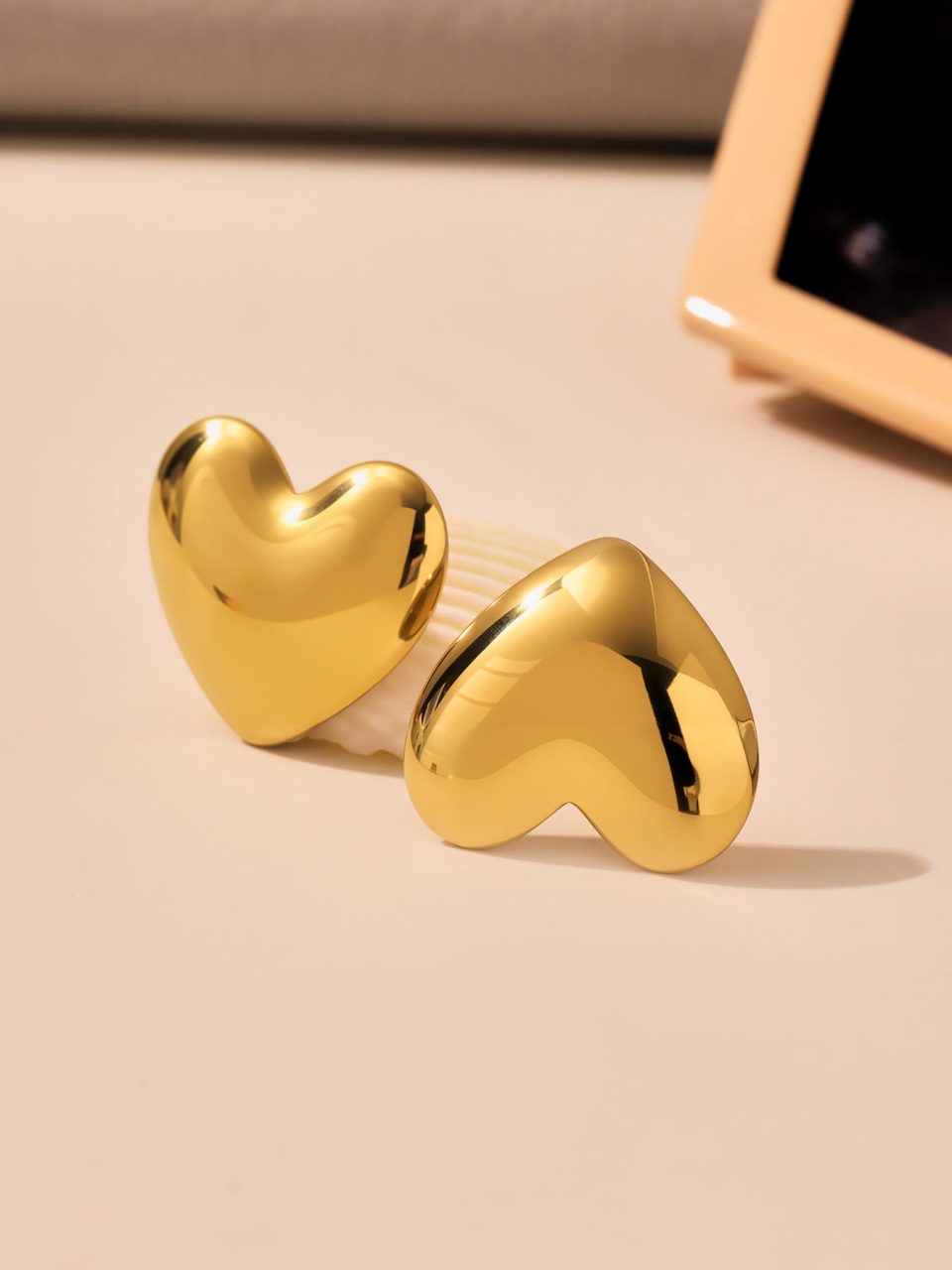 Bold Heart Stud Earrings styled in a modern lifestyle setting