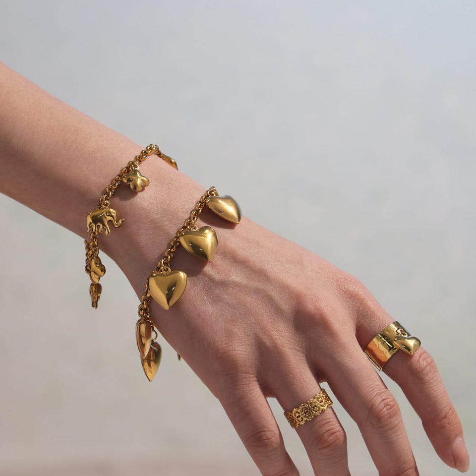Model wearing Five Heart Bracelet in gold, stainless steel jewelry, ocean-inspired look