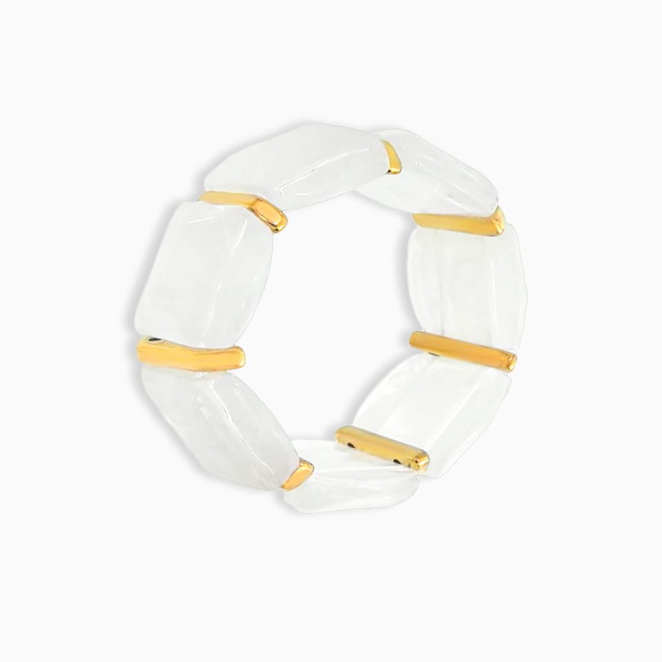 White chunky resin bracelet with stainless steel accent on plain background
