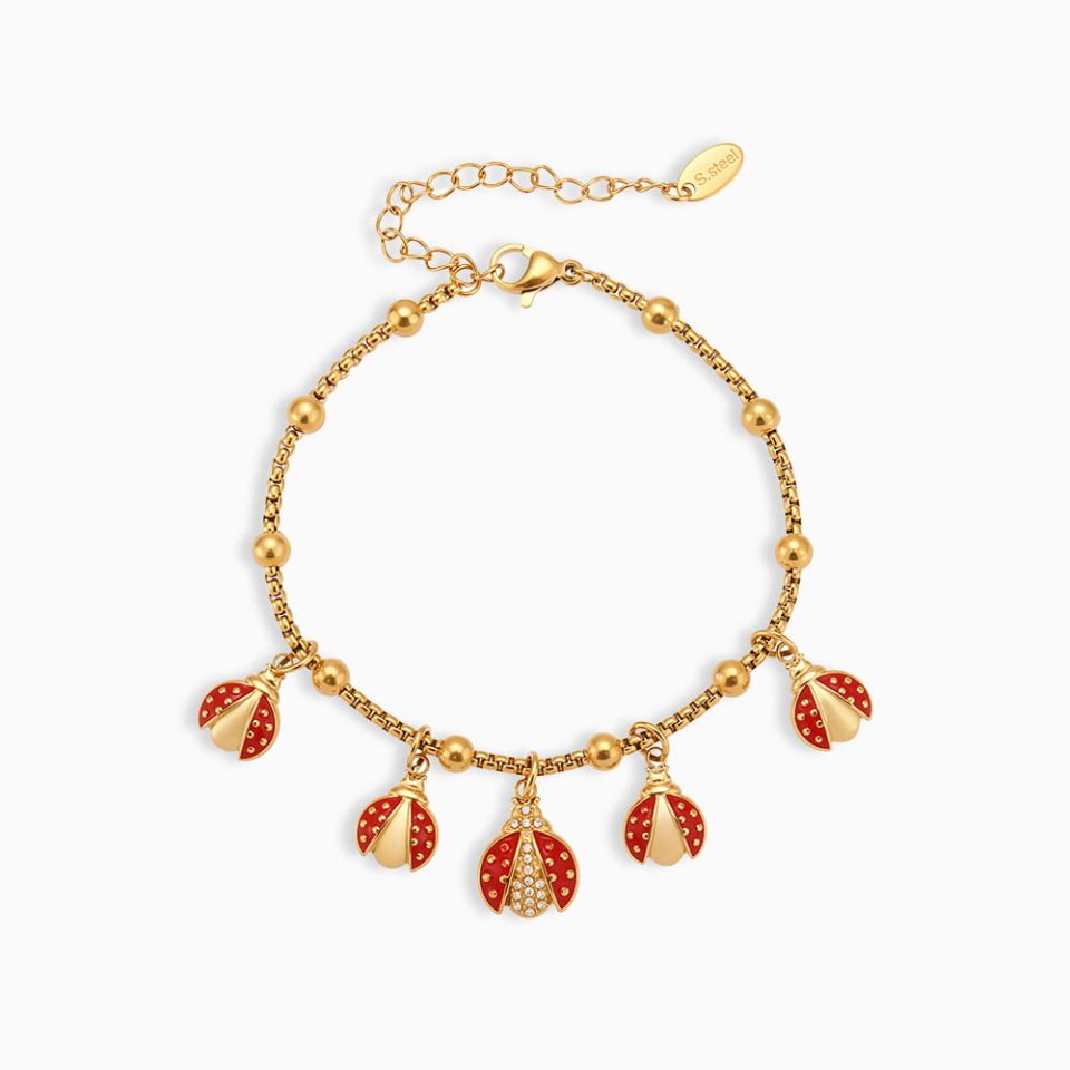 Red enamel ladybug bracelet in gold stainless steel with CZ charms, DIY beaded chain jewelry on white background