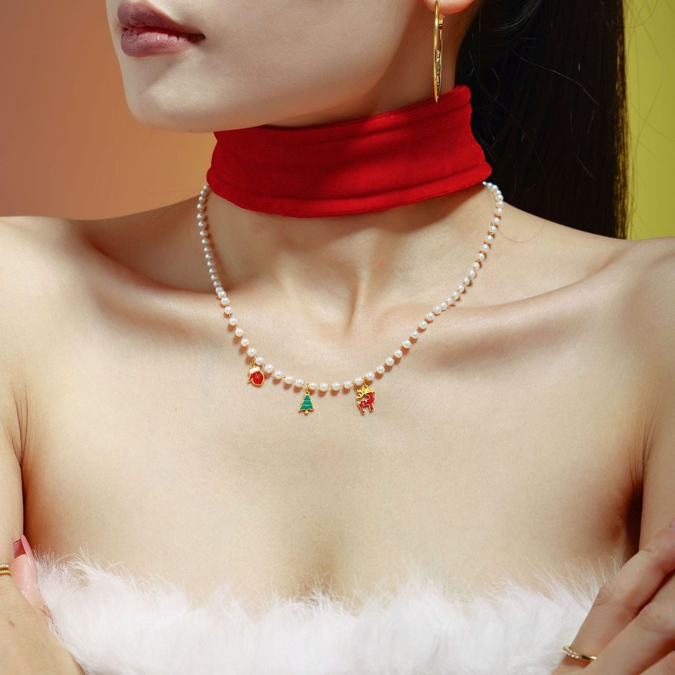 Model wearing a gold Christmas beaded multi-accessory necklace TXP183