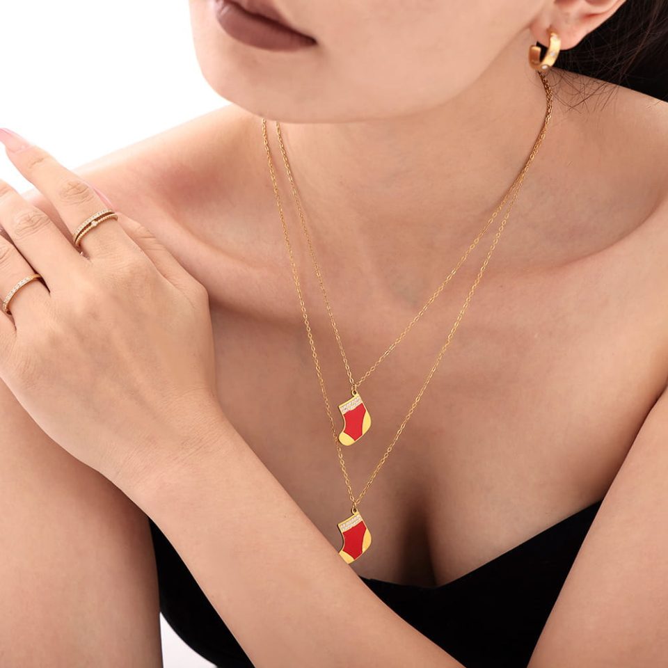 Model wearing a gold Christmas stocking necklace P1671