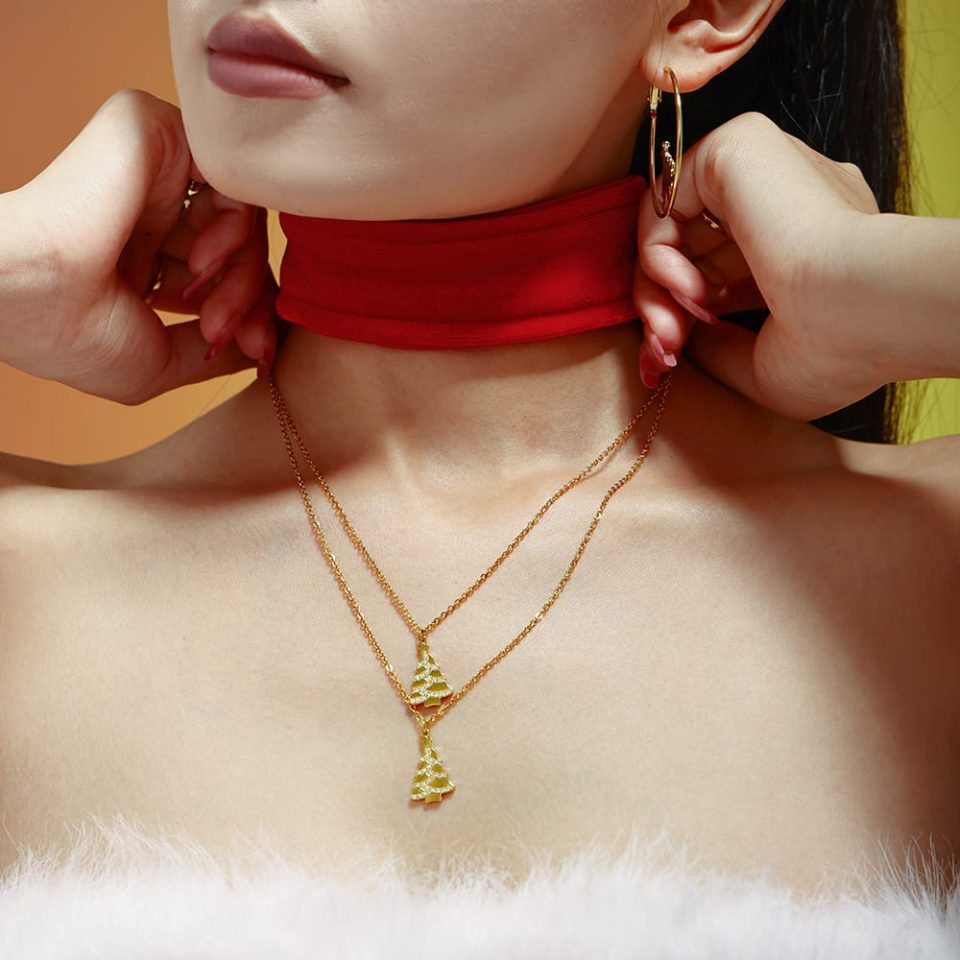 Model wearing a gold Christmas tree necklace inlaid with zircon P1673
