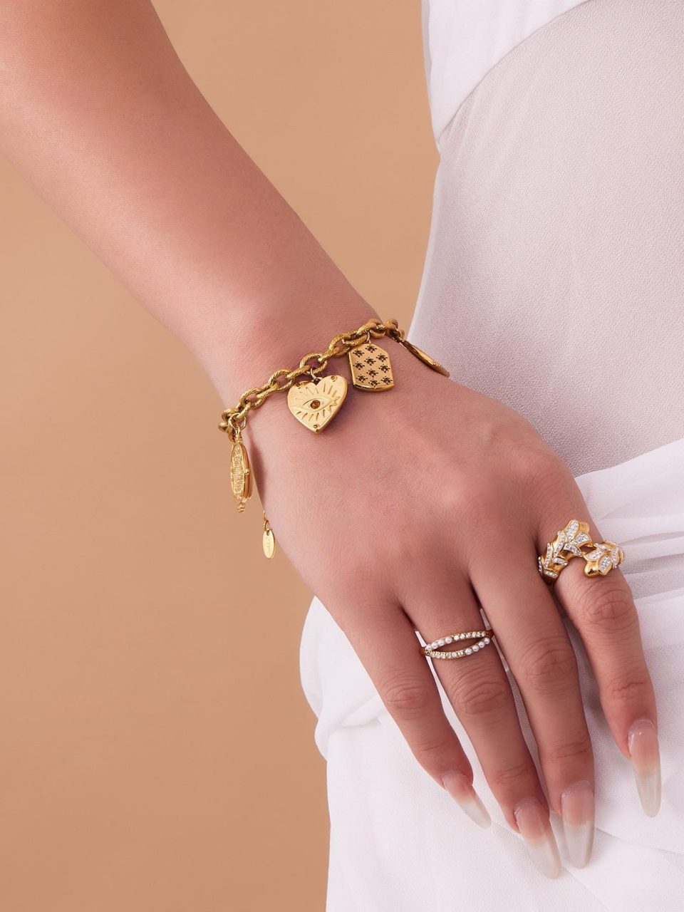 Model wearing a gold DIY multi-accessory bracelet TXE367-