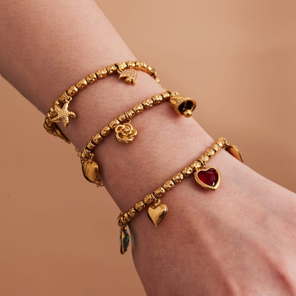 Model wearing a gold bell flower bracelet E172-