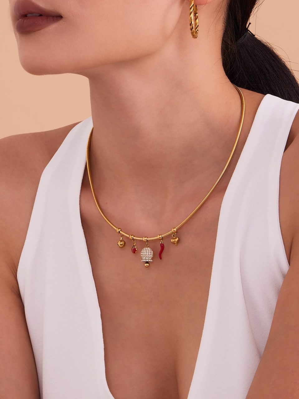 Model wearing a gold bell zircon necklace P1253