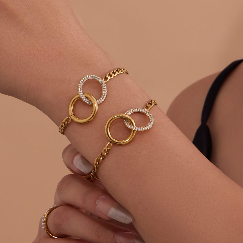 Model wearing a gold double-loop bracelet TXE400