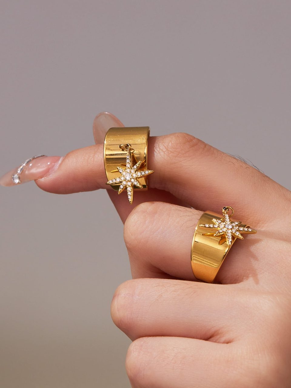 Model wearing a gold eight-pointed star zircon ring A074-B