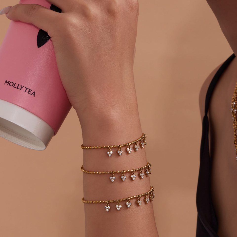 Model wearing Sparkling Geometric Tassel Diamond Bracelet in gold stainless steel