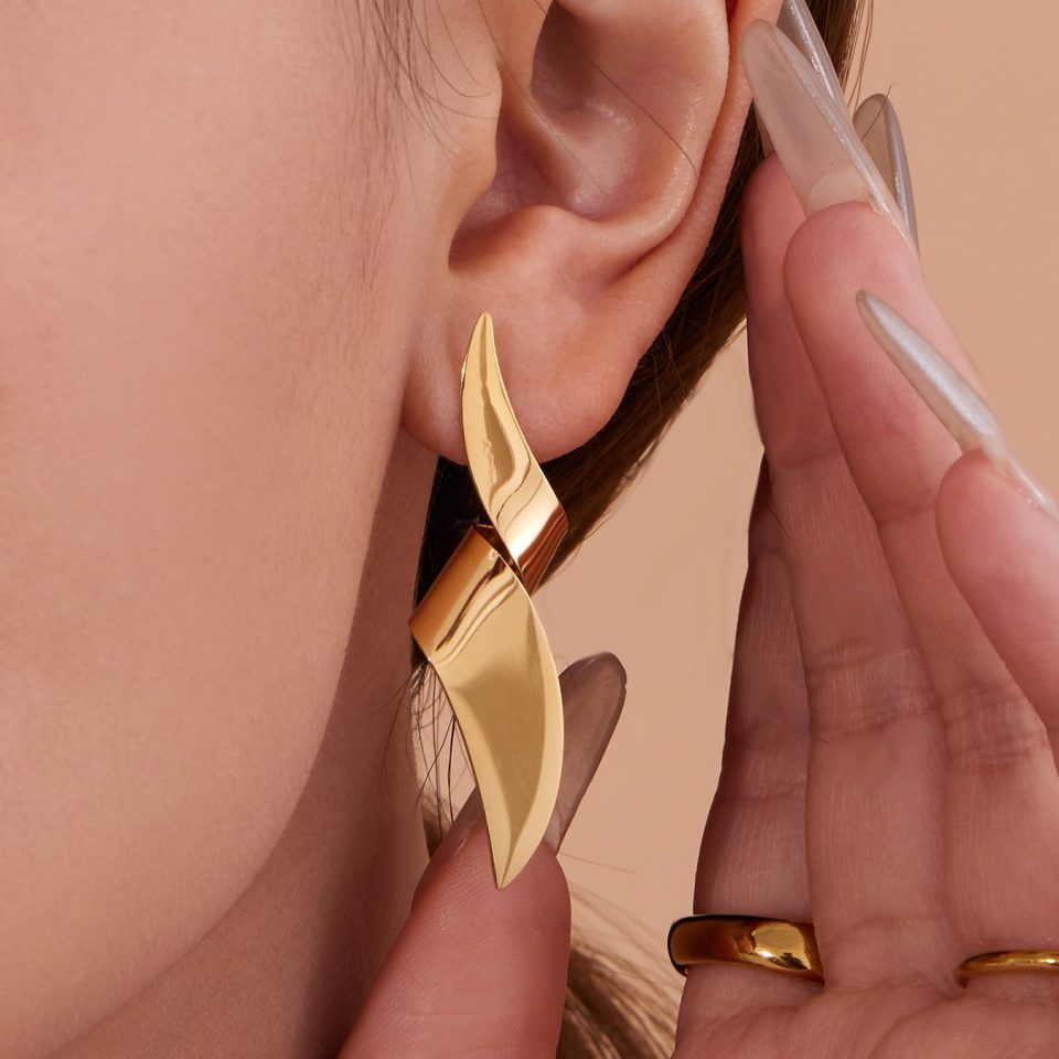 Model wearing gold geometric earrings TXF404