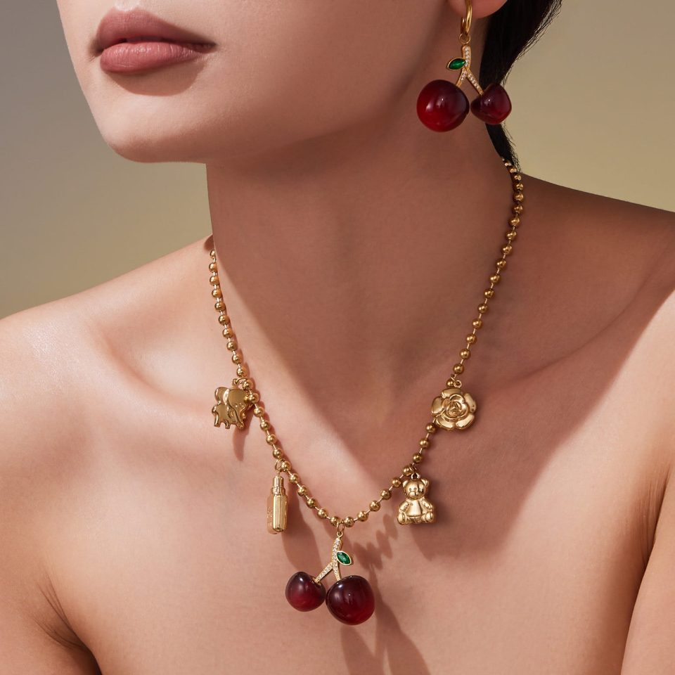 Model wearing a gold cherry DIY necklace TXP420