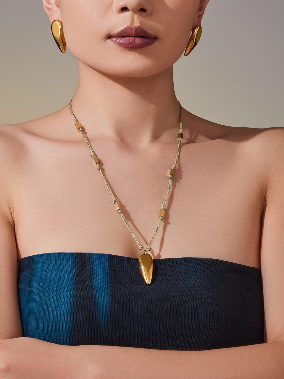 Model Wearing Polished Teardrop Necklace with Black Leather Cord