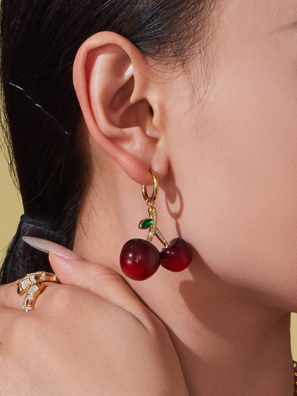 Model wearing burgundy cherry earrings TXF420